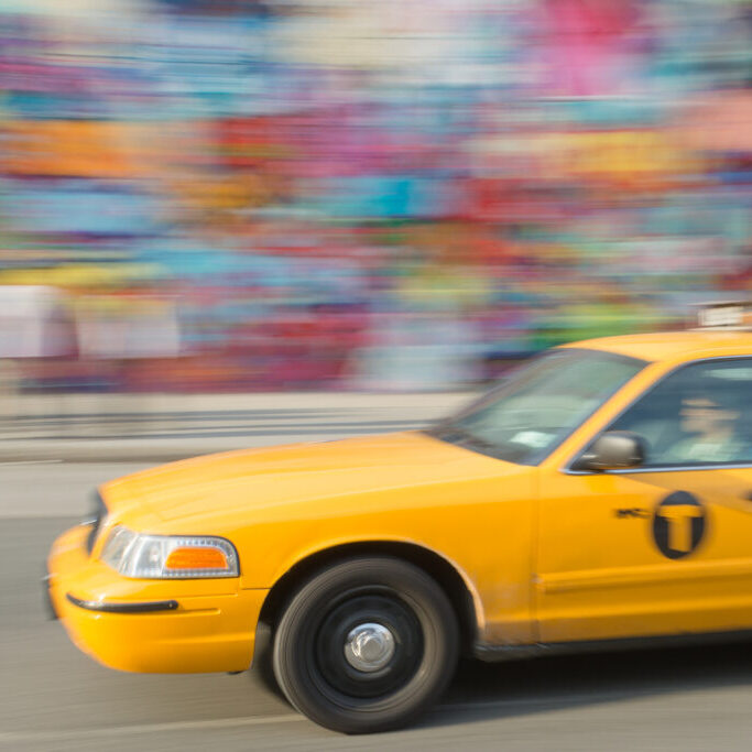 an accelerated taxi driven by a man