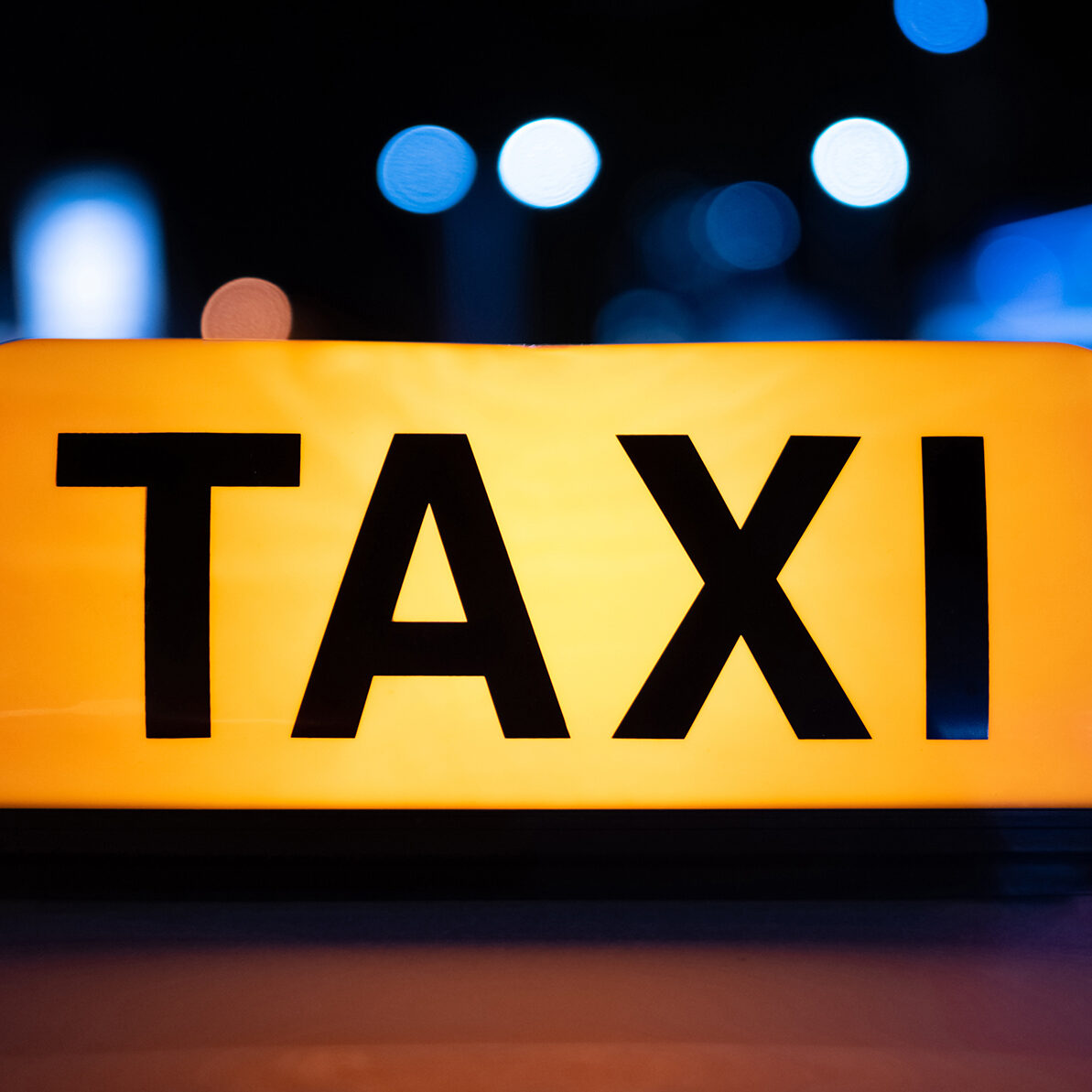 a yellow taxi roof sign