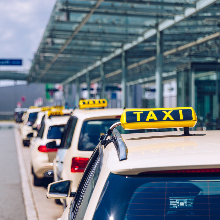 taxi cabs parked beside the road